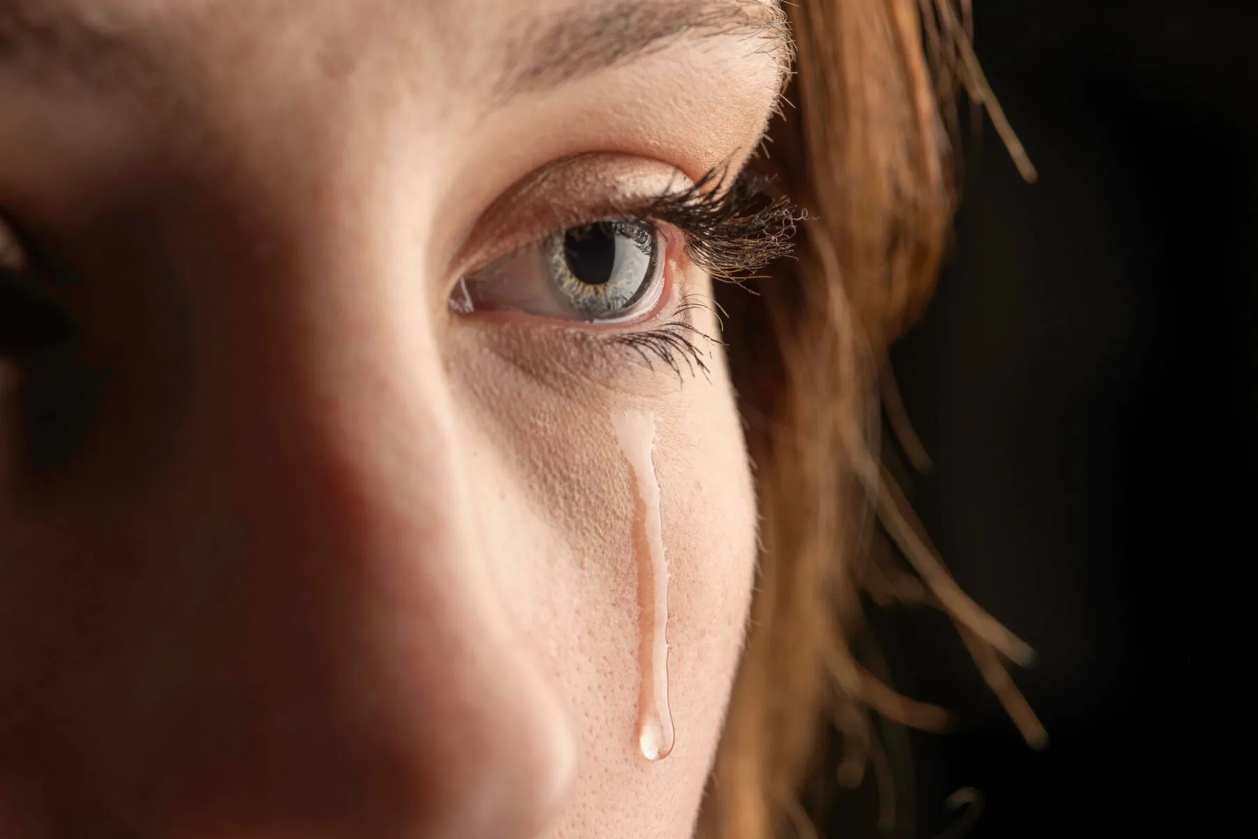 Tear dropping down a woman's face.