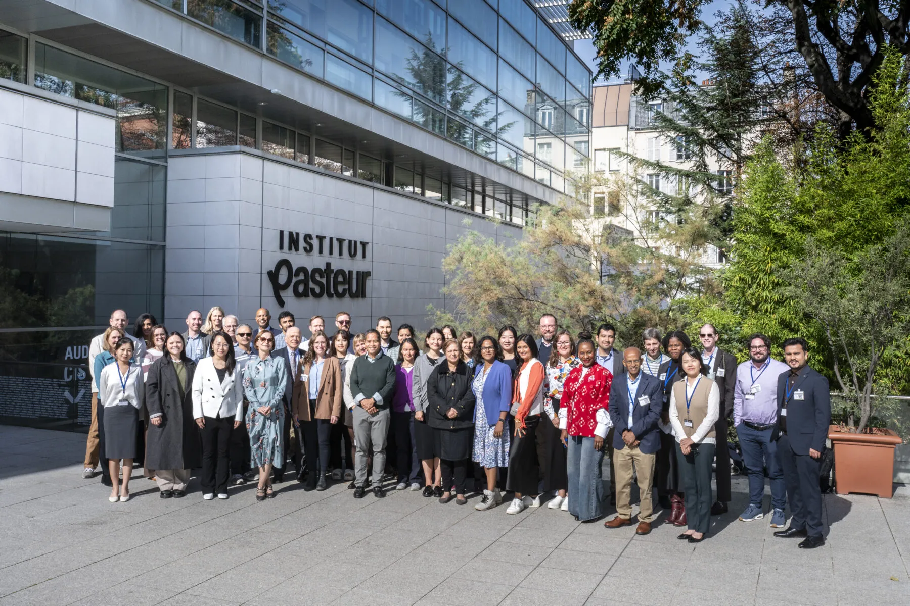 A large group of members of Cancer Grand Challenges team PROSPECT outside the Institut Pasteur in Paris, France.