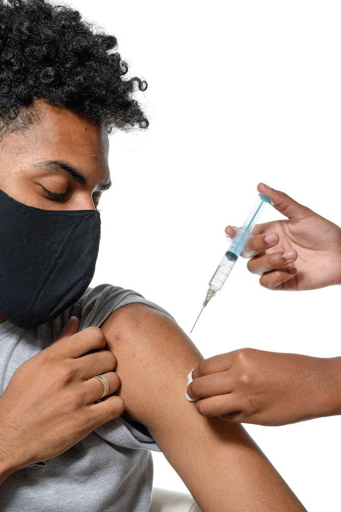 A teenage boy receives a dose of the HPV vaccine