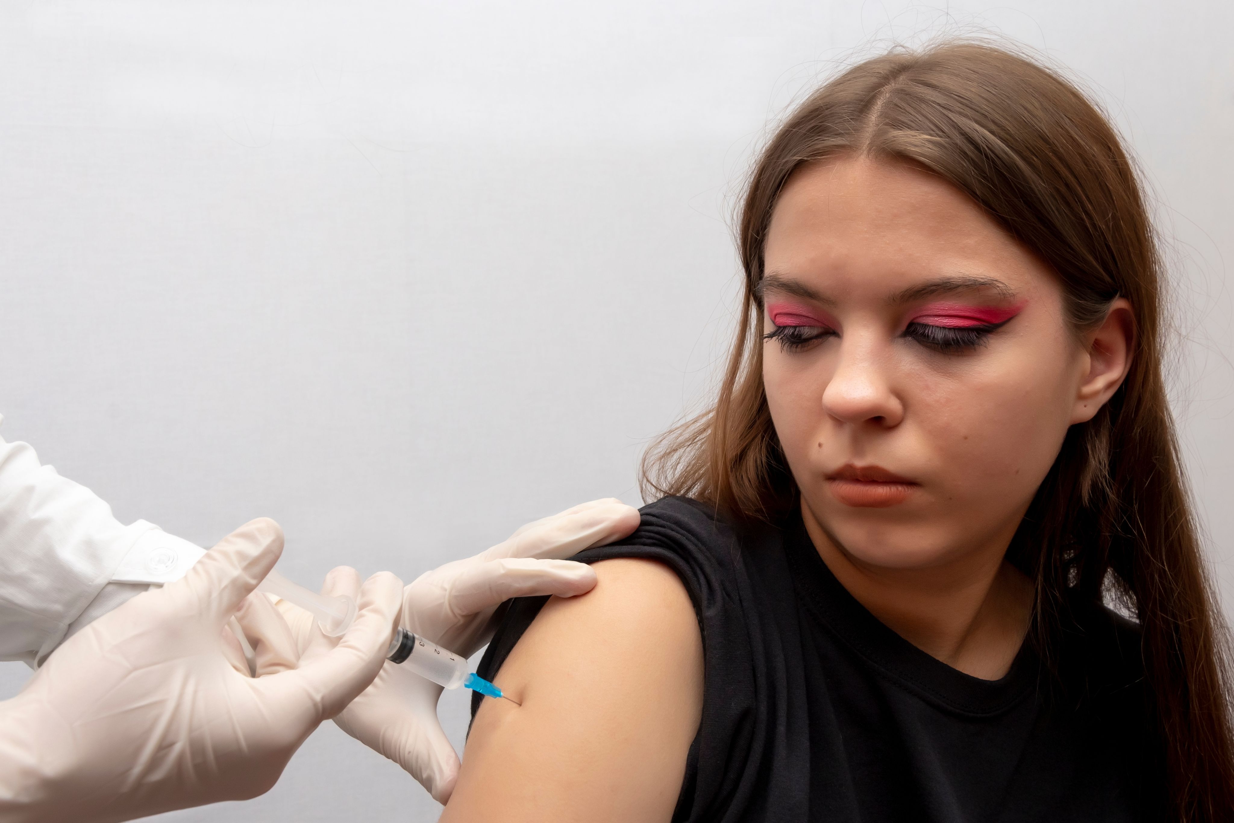 A teenage girl receiving a dose of the HPV vaccine