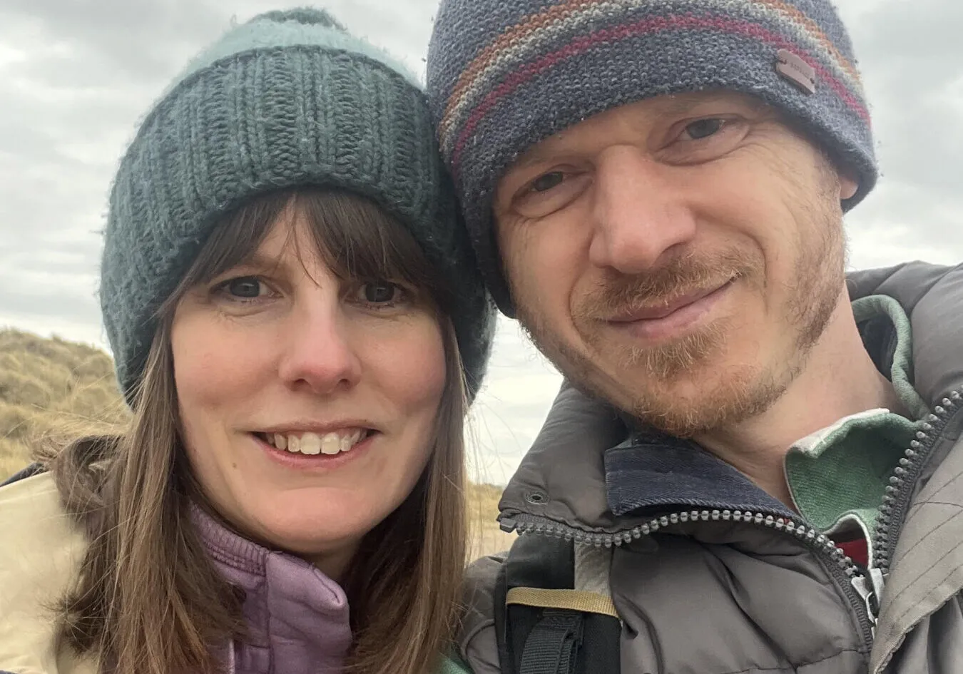 Two people wearing winter hats.