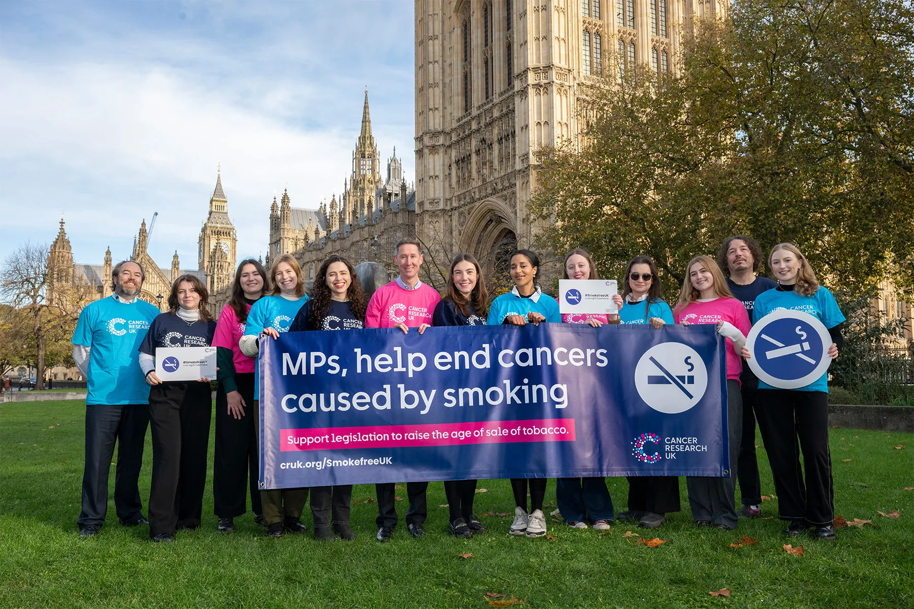 Cancer Research UK Smokefree UK policy team holding a banner in front of parliament.