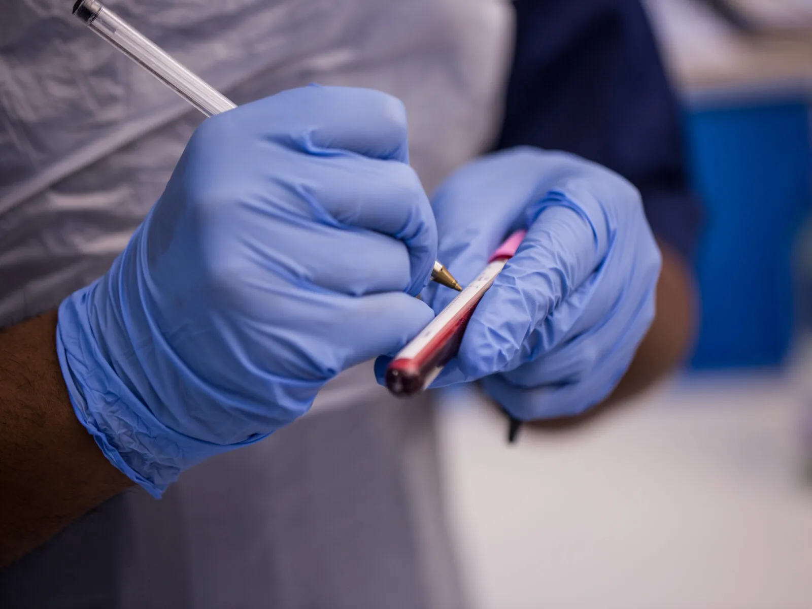 Healthcare professional labelling a blood sample