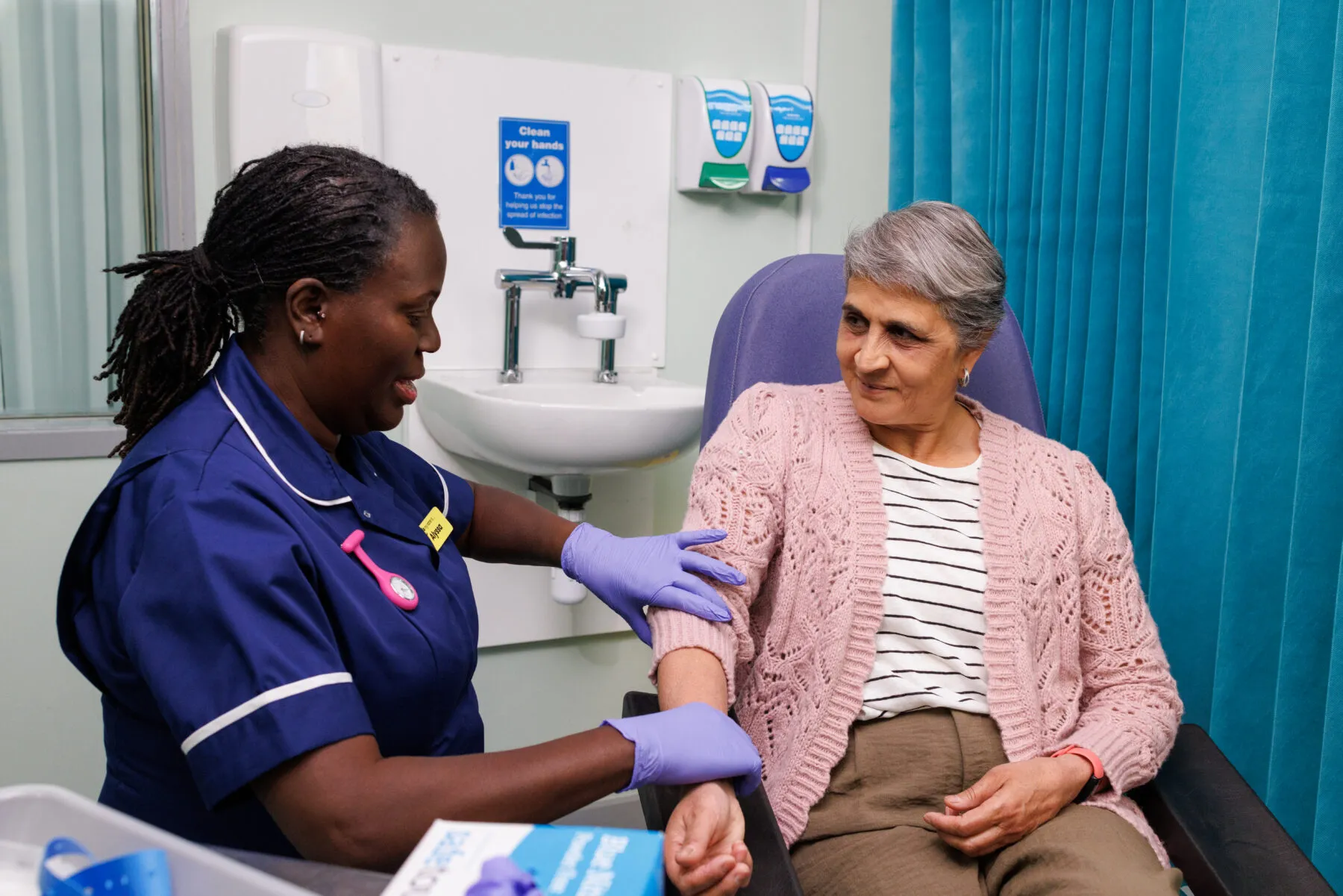 A nurse and patient in a clinical setting