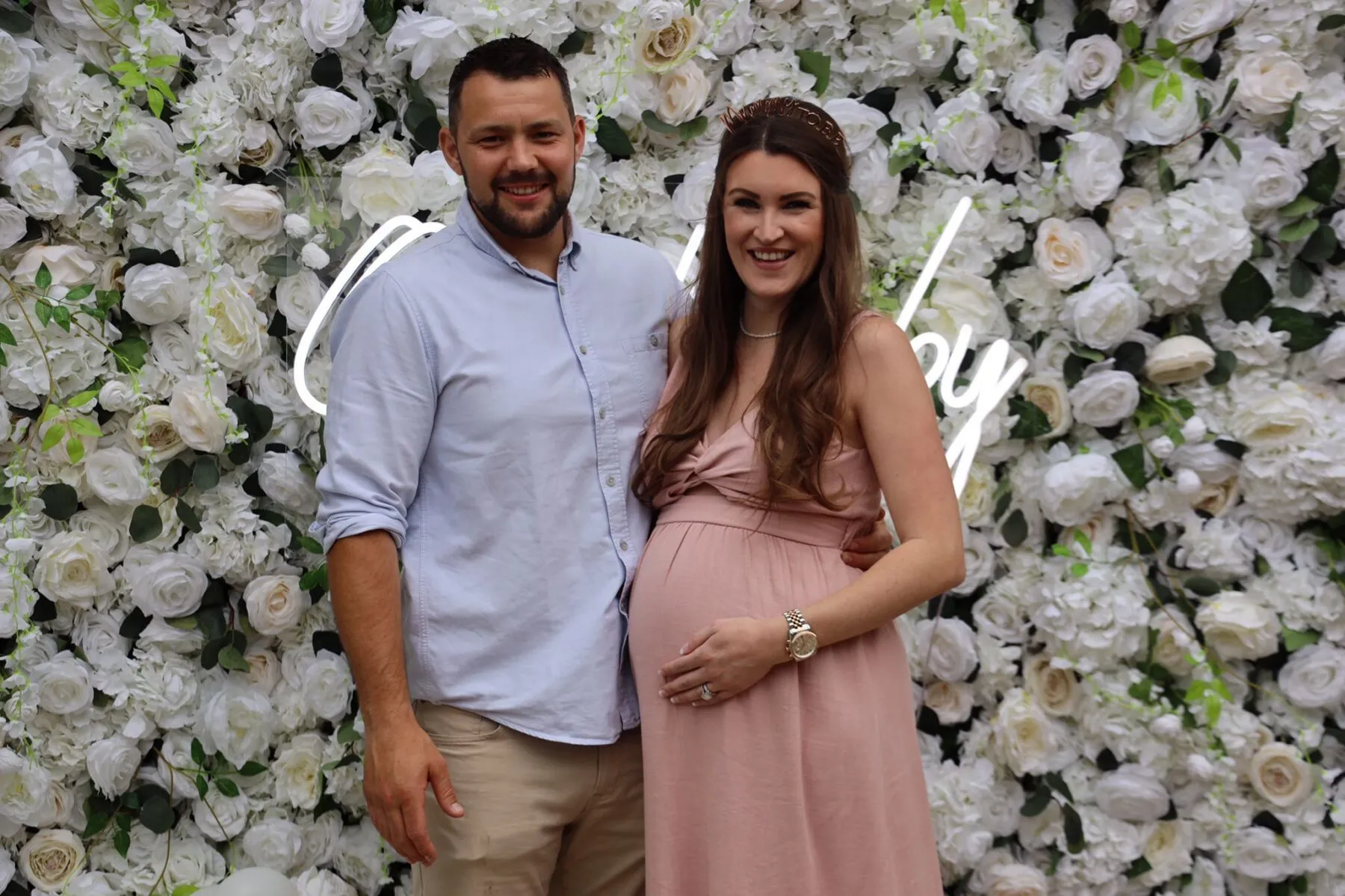 A man and a pregnant lady standing together.