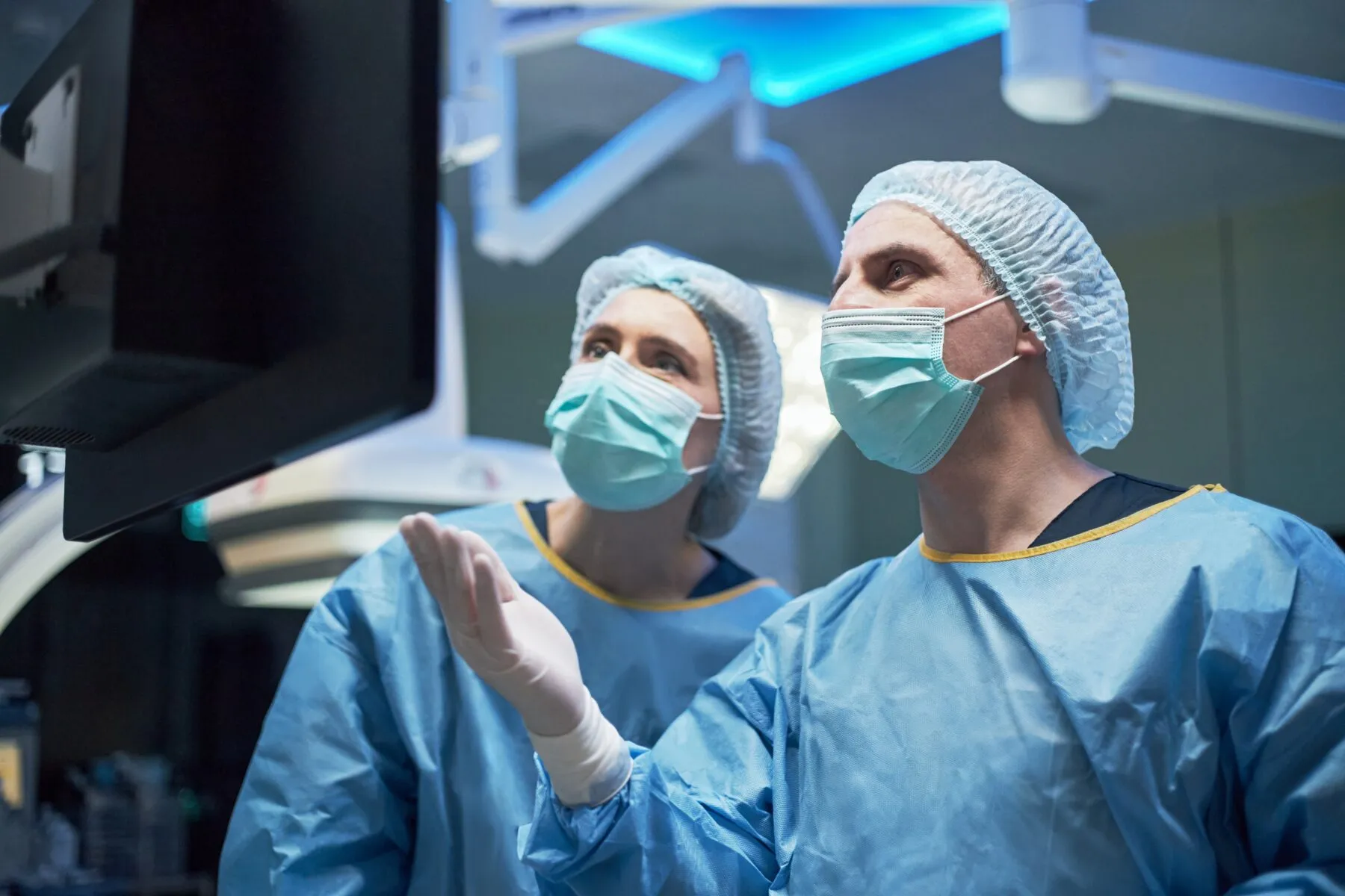 Surgeons looking at a screen