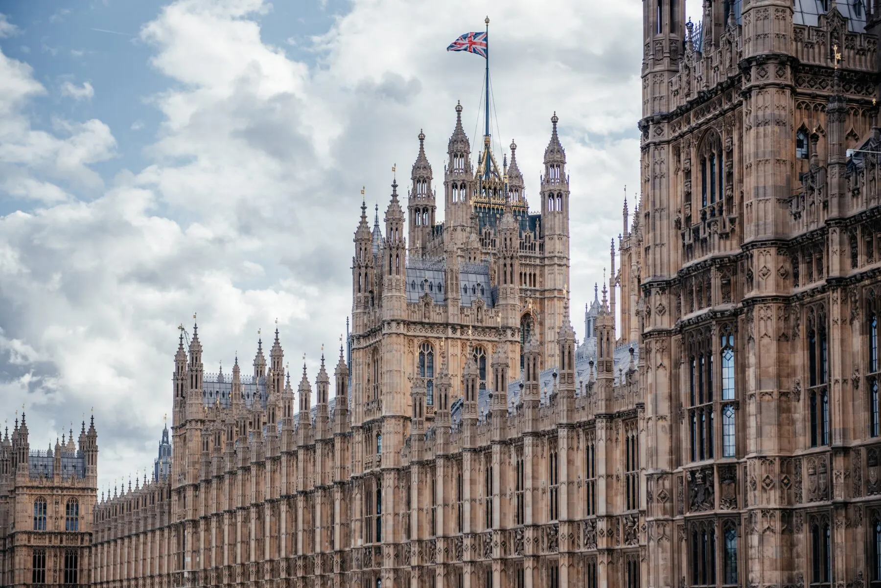 UK parliament building with UK flag waving.